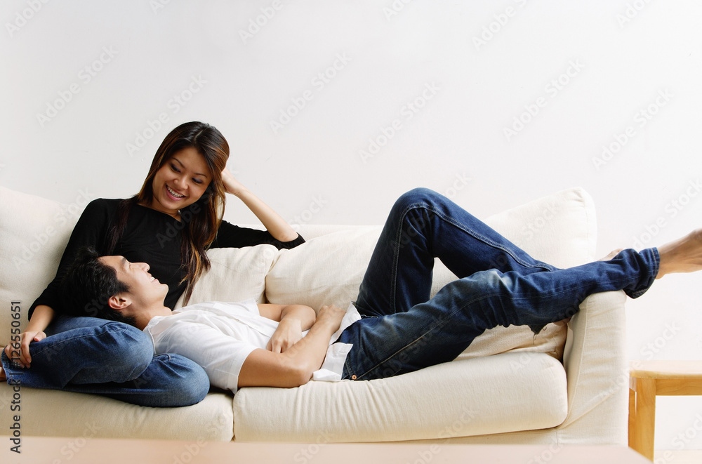Couple on sofa, man lying on womans lap Couple on sofa, man lying on womans lap