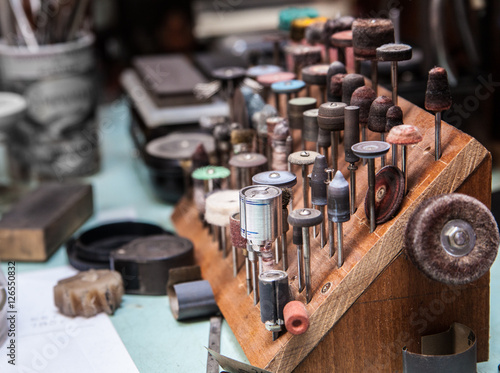 A lot of dremel bits at jeweler's workplace
