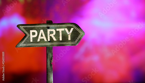 Old wooden arrows road sign with party white paint text on colorful dancing bokeh background. Concept night Dance Party Poster Background Template or Festival  DJ poster design.