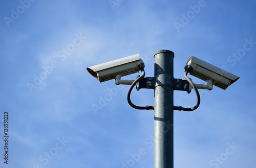 Security camera on blue sky background