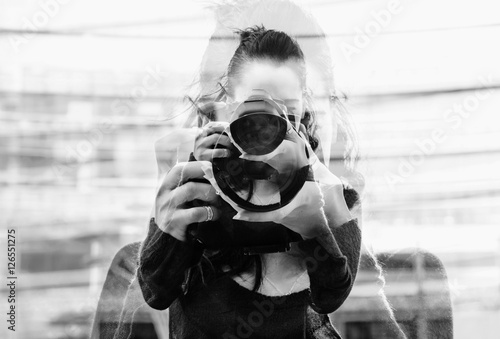 Monochrome double exposure of girl portrait taking photos