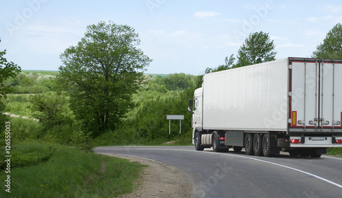 The truck on asphalt road.