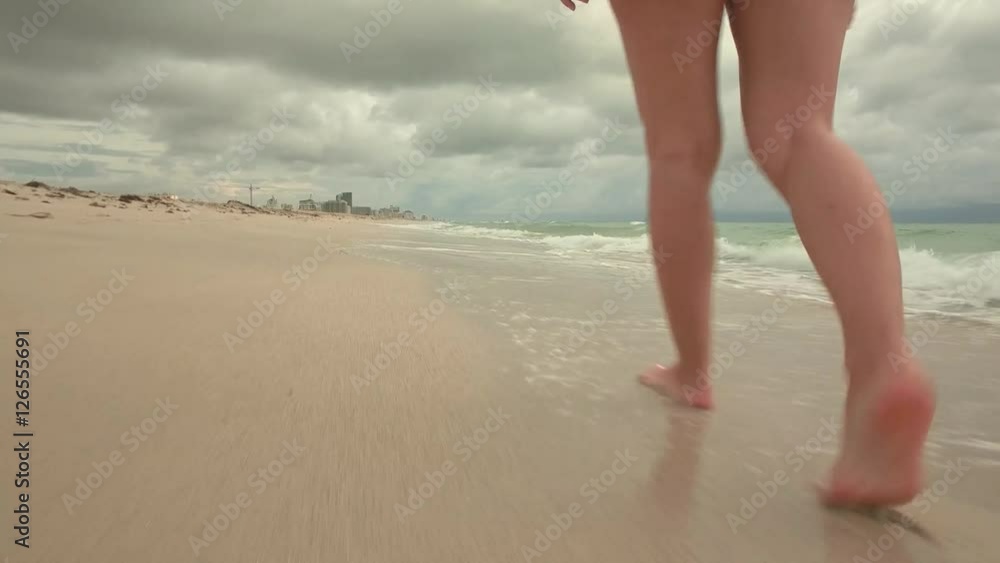 Beautiful woman walking on South beach, Miami, USA Beautiful woman walking on South beach, Miami, USA
