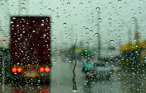 Windshield wipers from inside of car, season rain. traffic jam.