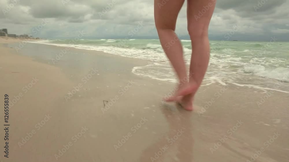 Beautiful woman walking on South beach, Miami, USA Beautiful woman walking on South beach, Miami, USA