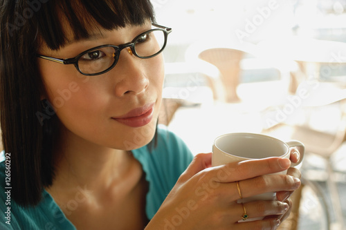 Wallpaper Mural Young woman in black glasses, with coffee cup Torontodigital.ca