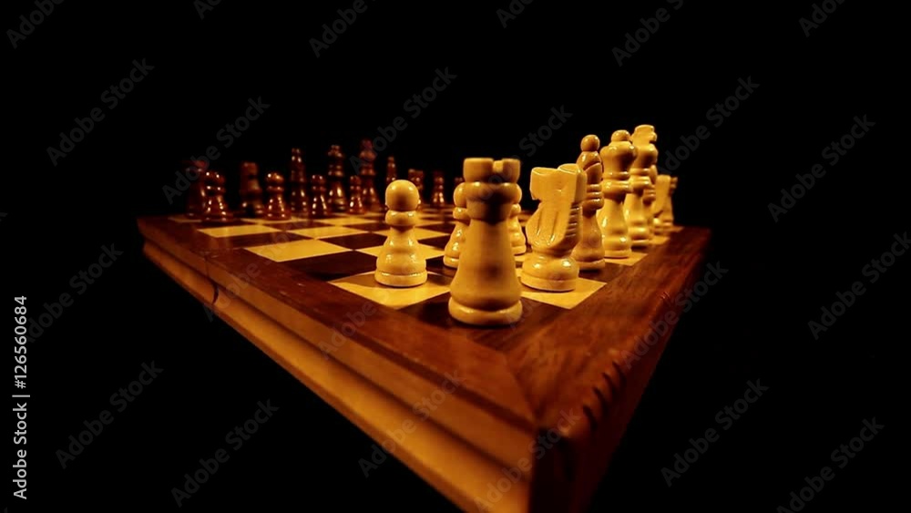 Zoom out of a chess board with its figures on it ready for a new game ...
