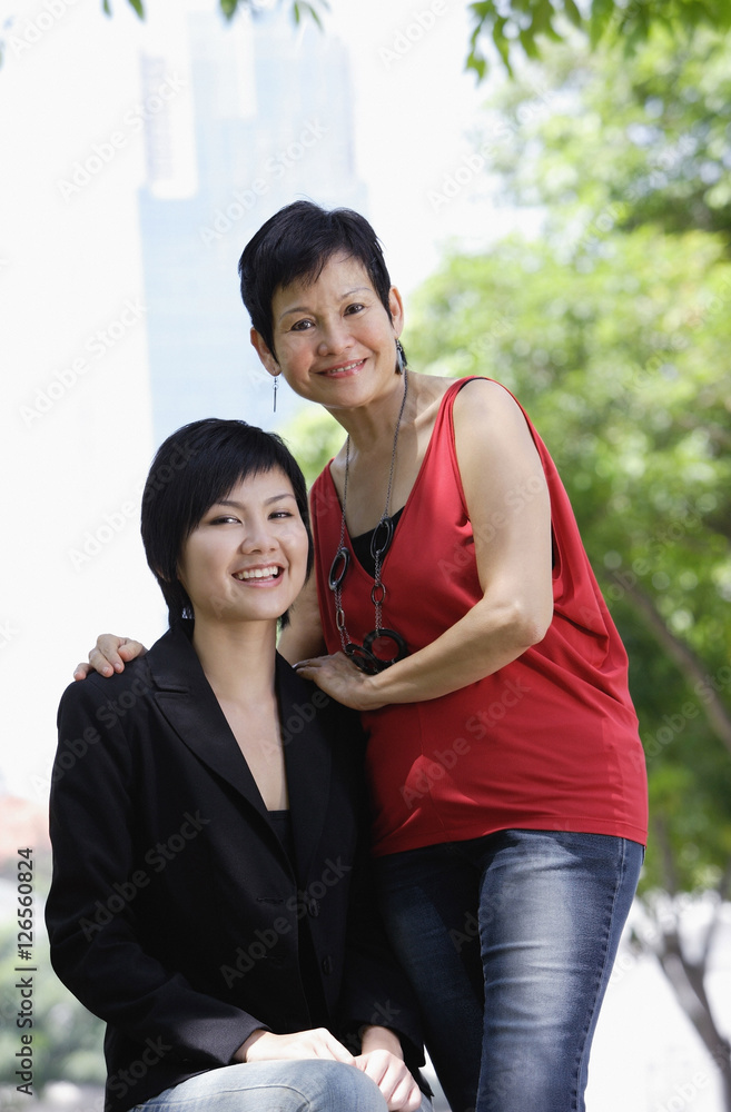 Mother and adult daughter looking at camera Mother and adult daughter looking at camera
