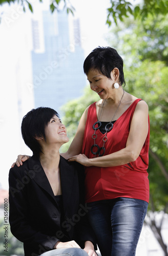 Mother and adult daughter looking at each other