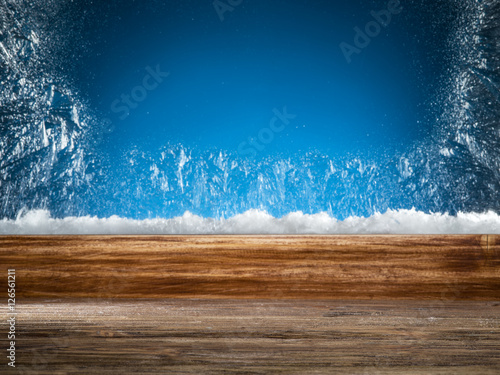 Wooden sill and frozen window. Christmas or New Year background.