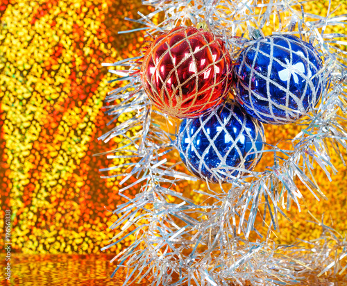 blue and red xmas balls on a sparkling gold background