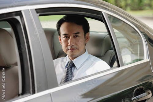 Businessman sitting in car © Alexander