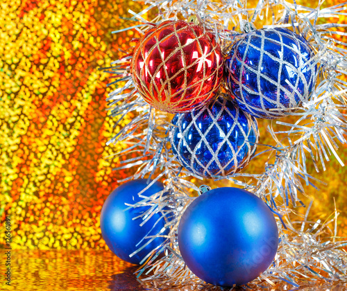 blue and red xmas balls on a sparkling gold background