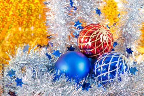 Silver sparkling tinsel and christmas balls on gold background