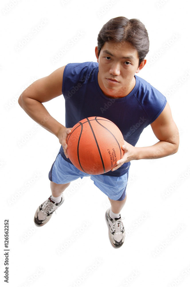 Fototapeta premium Young man holding basketball