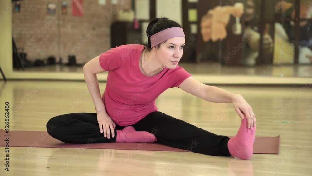 Happy woman doing fitness exercises on a mat Happy woman doing fitness exercises on a mat