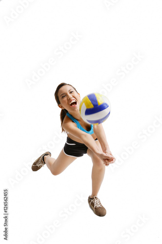 Young woman hitting volleyball