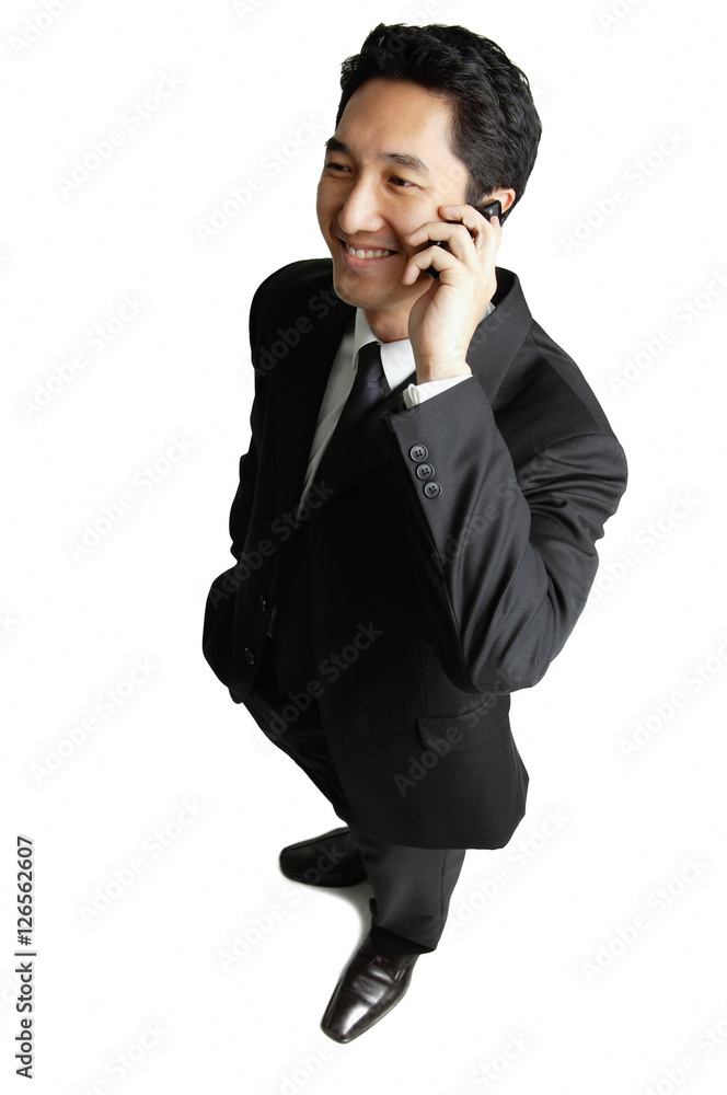 Businessman using mobile phone, smiling Businessman using mobile phone, smiling
