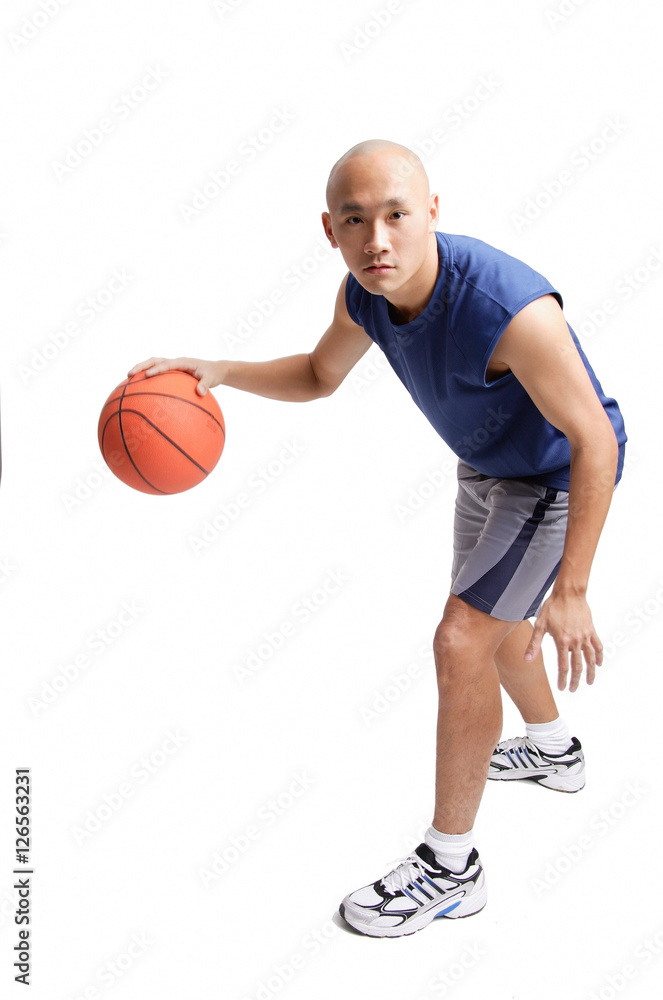 Young man dribbling basketball Young man dribbling basketball