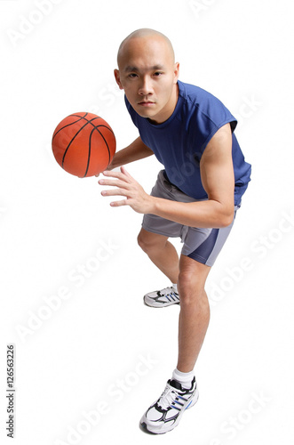 Young man holding basketball, preparing to shoot