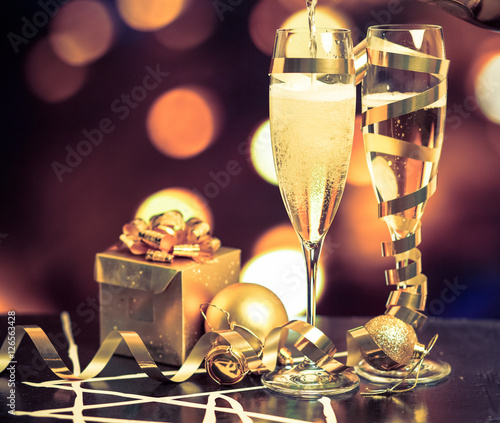 Glasses with champagne against holiday lights