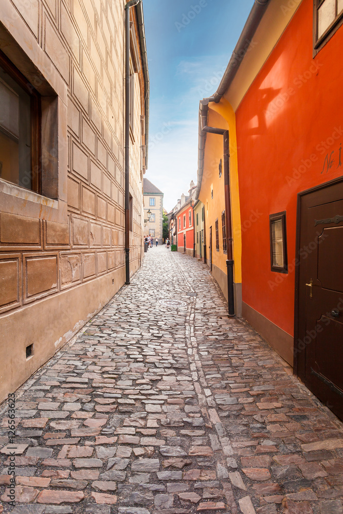 Golden street inside of Old Royal Palace in Prague, Czech Republic. Multicolored houses authentic retro.