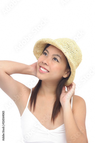Young woman wearing hat, looking away, smiling