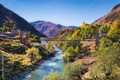 Bridge cross river in Stepantsminda village, Georgia photo