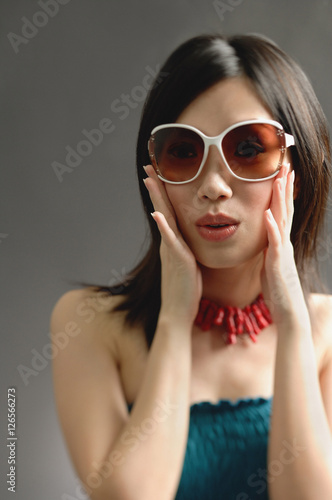 Wallpaper Mural Woman wearing large sunglasses, hands on face Torontodigital.ca