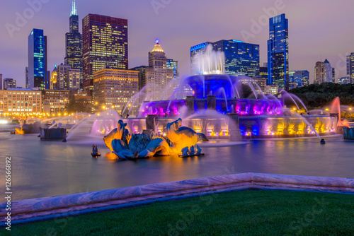 Chicago skyline panorama with skyscrapers and Buckingham fountain in Grant Park at night lit by colorful lights. photo