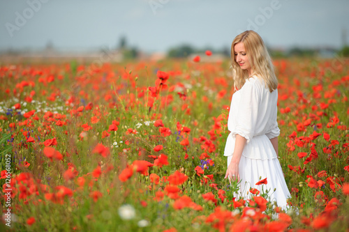 girl in white dress in the poppy field