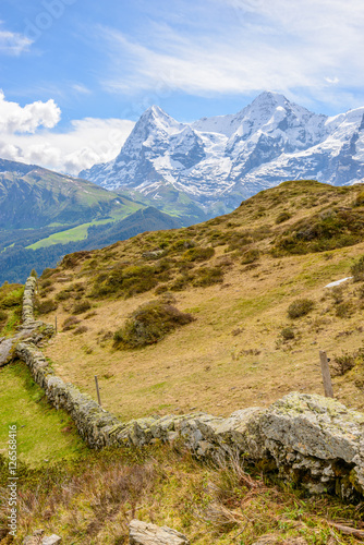 swiss landscape. stone fence over mountains.