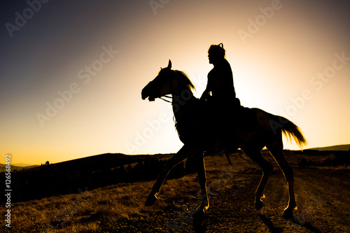 the man riding the skyline at sunset