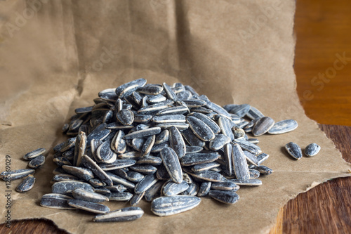 Grilled sunflower seeds with sea salt and spices on the wooden background