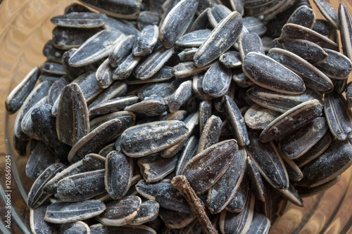 Grilled sunflower seeds with sea salt and spices on the wooden background