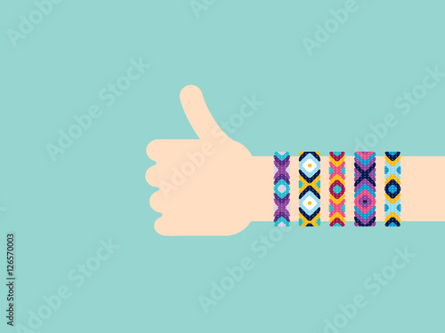 Hitchhiking hand with hippy friendship bracelets. Thumb up sign