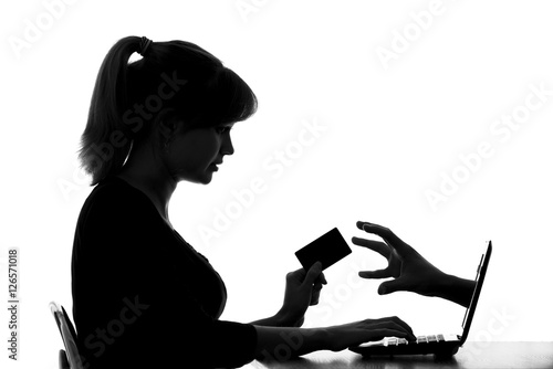 Canvas Print silhouette of a woman shows the danger of online shopping by card