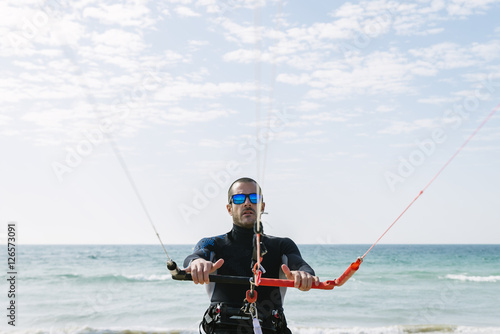 Portrait of handsome man kitesurfer.
