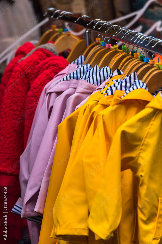 Fototapeta premium Bright raincoats hanging at a fashion store