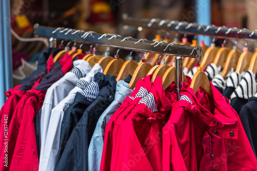 Bright raincoats hanging at a fashion store