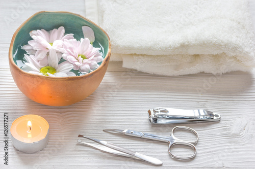 spa nail care with tea candle on wooden background