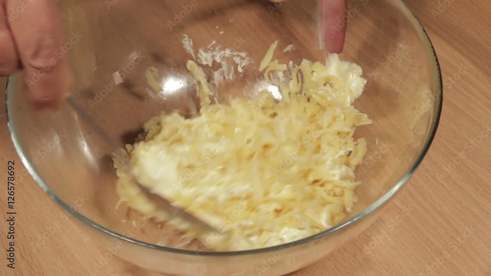 Mixing the mayonnaise with the grated cheese Mixing the mayonnaise with the grated cheese