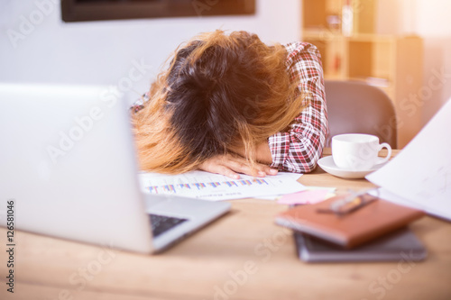 Young business woman tired and headache about her work.