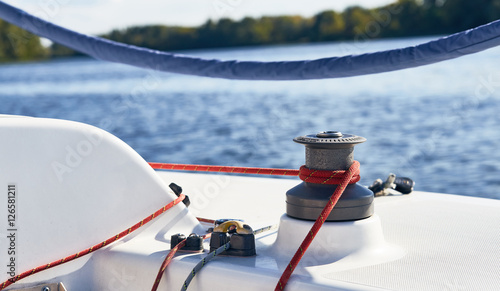 Sheet on the winch on a yacht on the background of blue water