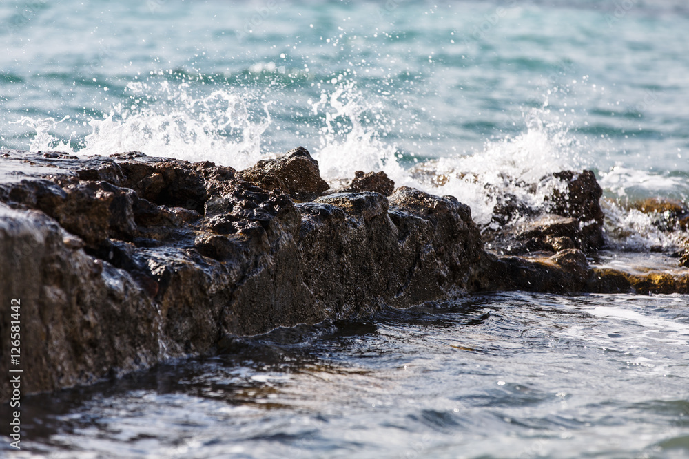 The waves break on the rocks and the splashes of water. Evening. The waves break on the rocks and the splashes of water. Evening.