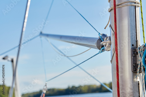 The spinnaker pole is rigged to run from the base of the mast to windward over the side of the boat.