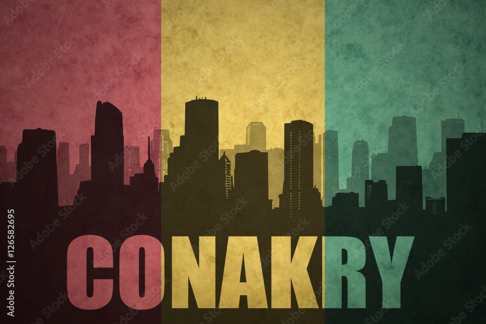 abstract silhouette of the city with text Conakry at the vintage guinea flag