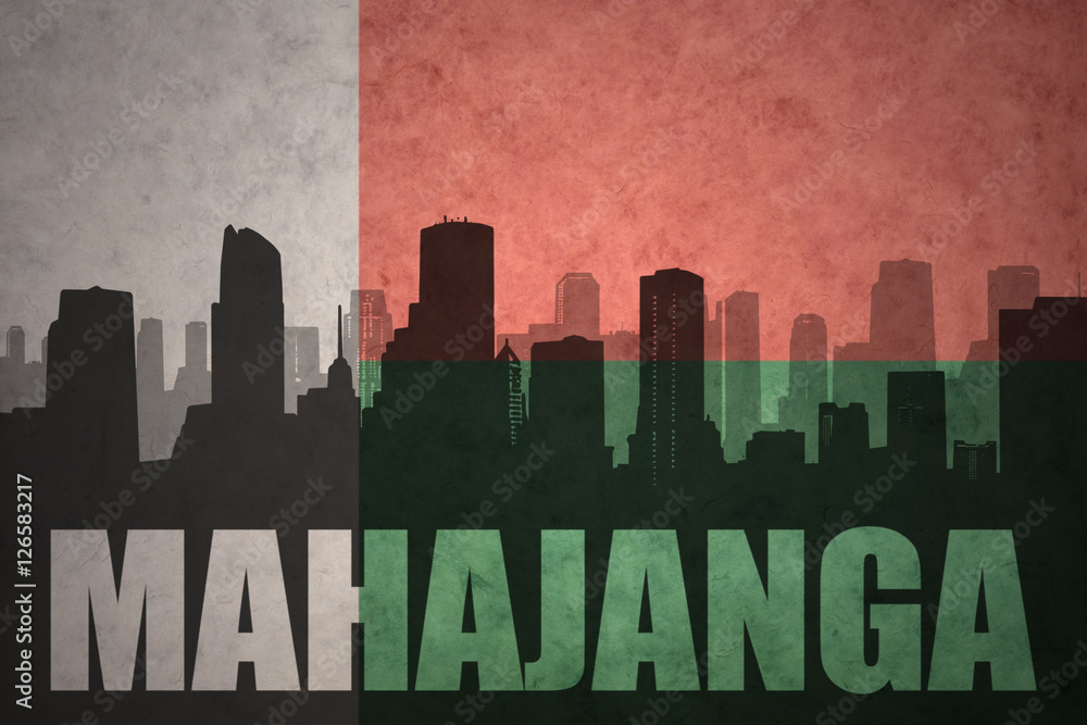 abstract silhouette of the city with text Mahajanga at the vintage madagascar flag