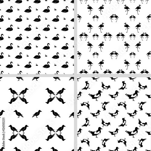 Set of four seamless patterns with different birds. The crow, flamingo, swan, magpie. Black silhouettes on a white background. Design for fabric and decor.