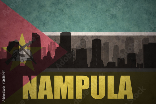 abstract silhouette of the city with text Nampula at the vintage mozambican flag